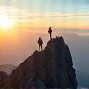 Hikers reaching a mountain peak with a stunning panoramic view
