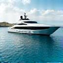 Luxury yacht sailing on azure waters with a scenic coastline in the background